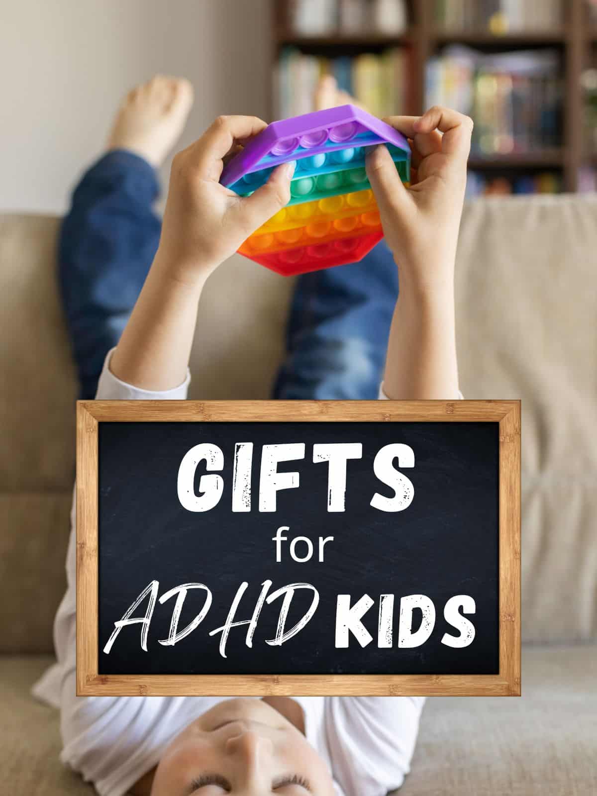 A child on a sofa with his feet in the air holding a colorful fidget toy and the text "gifts for ADHD kid."