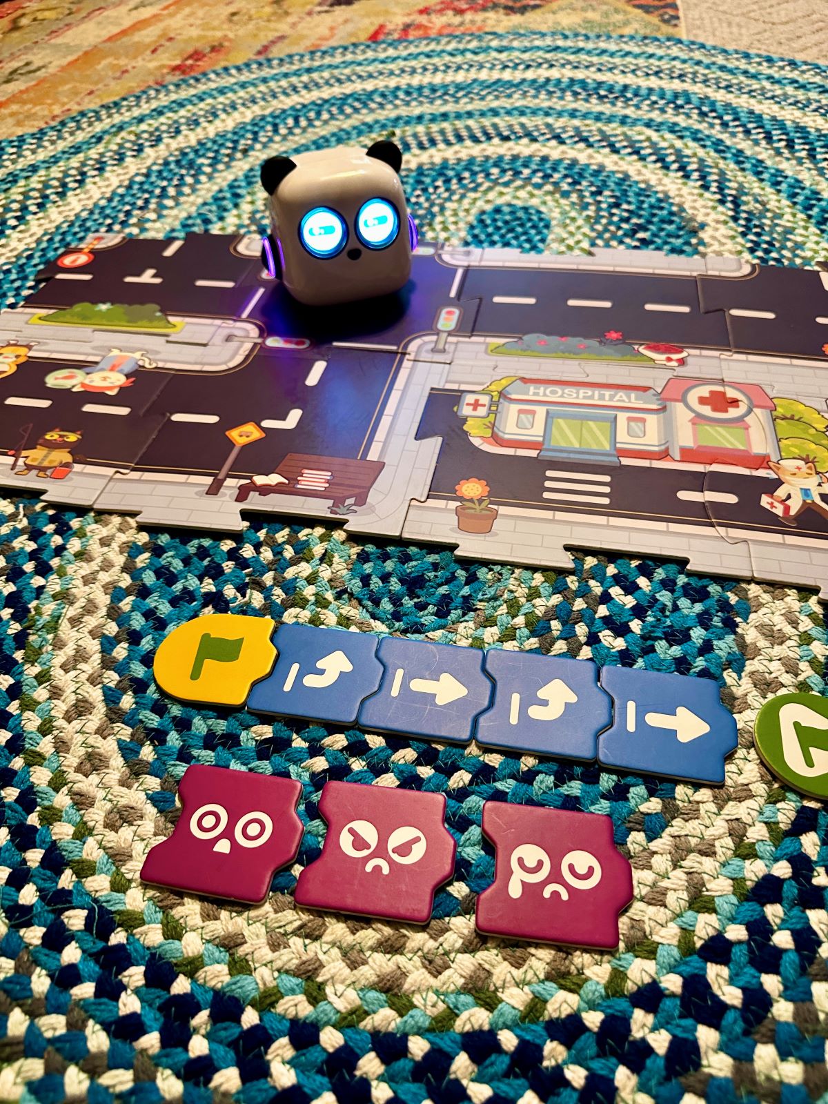 The mTiny robot toy set up with different emotion card options.